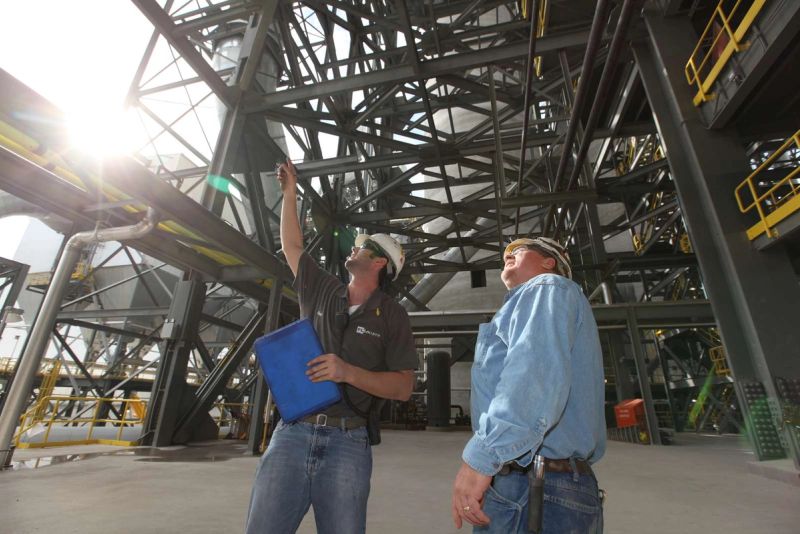 On-site engineers reviewing steel structure during cement plant walkthrough inspection