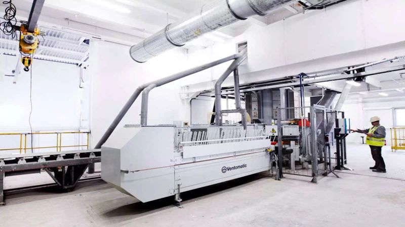 Automated Ventomatic packing line with operator control panel in high-efficiency cement facility