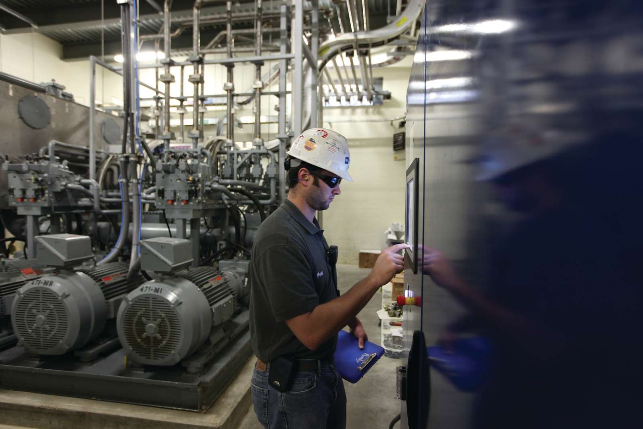 Engineer performing system check on pneumatic conveying equipment powering automated material transport