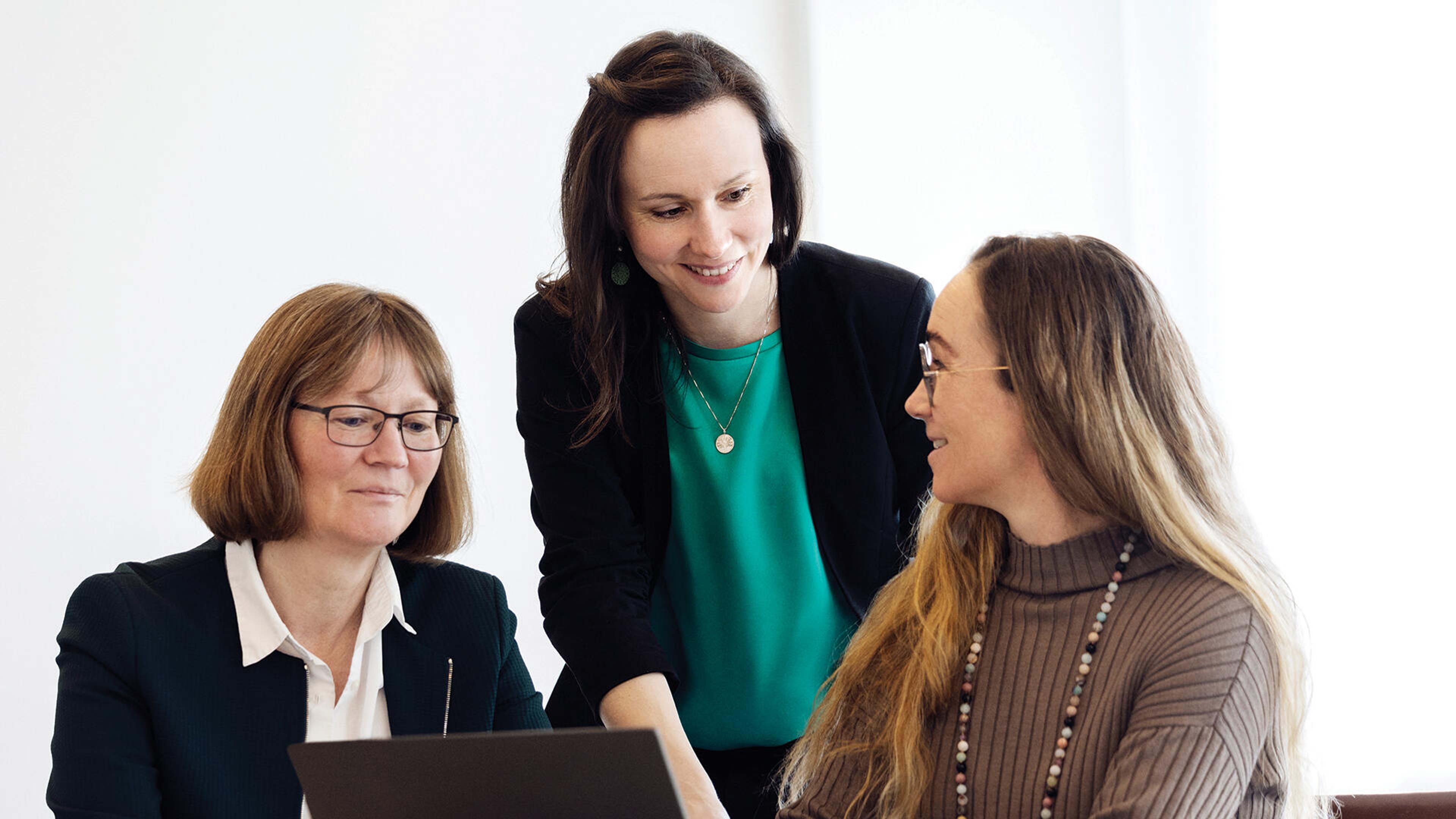 Three FLSmidth Cement professionals are seated while discussing sustainability